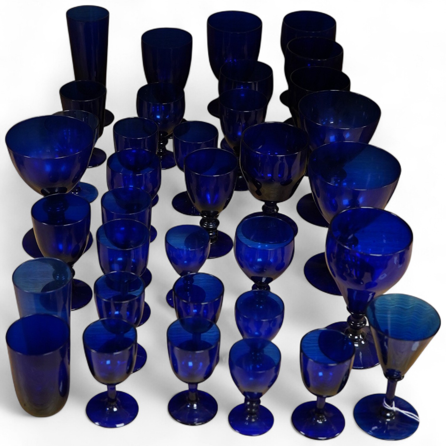 A collection of 19th century and later Bristol blue drinking glasses of various sizes, largest 16cm high